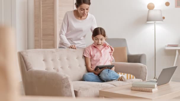 Lockdown Caucasian Girl Sitting Sofa Living Room Using Tablet While — Stockvideo