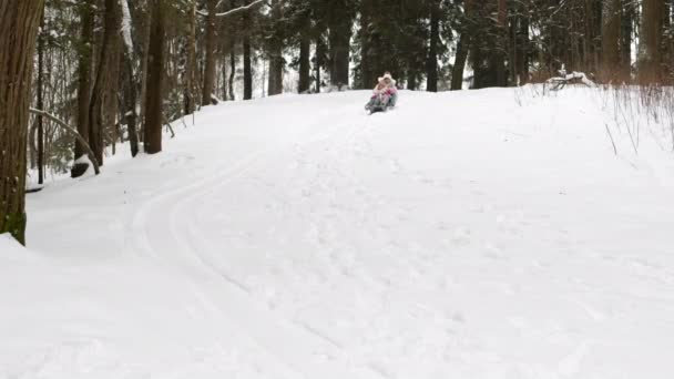 Long Steadicam Woman Girl Sitting Together Slides Going Hill Snowy — Stock Video