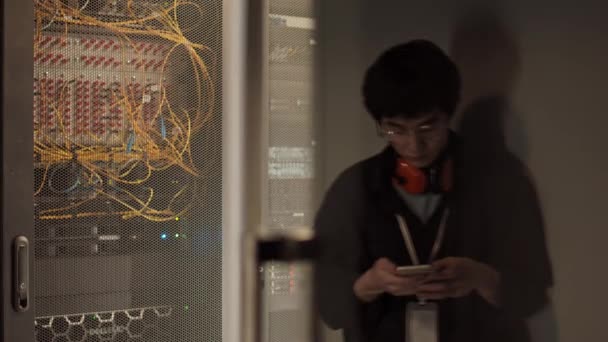 Medium Shot Young Asian Technician Wearing Streetwear Headphones Standing Server — Stock Video