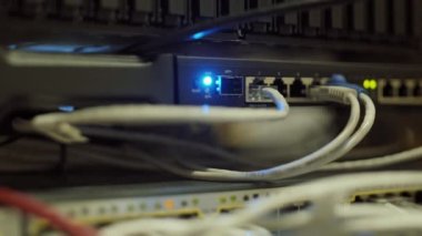 Close up of network panels of mainframe with wires, switches and LEDs in server room