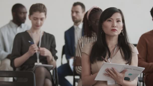 Medium Close Young Asian Businesswoman Sitting Conference Room Foreground Diverse — Stock Video