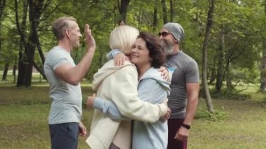 Yarıştan önce parkta spor giyinen Kafkas erkek ve kadınların orta boy fotoğrafları.