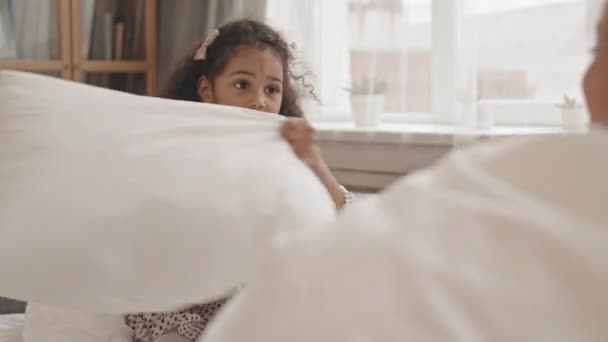 Medium Long Shoulder Cheerful Mixed Race Little Girl Having Pillow — Stock Video