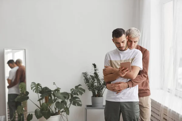 Front View Portrait Contemporary Gay Couple Embracing While Looking Tablet — Stock Photo, Image