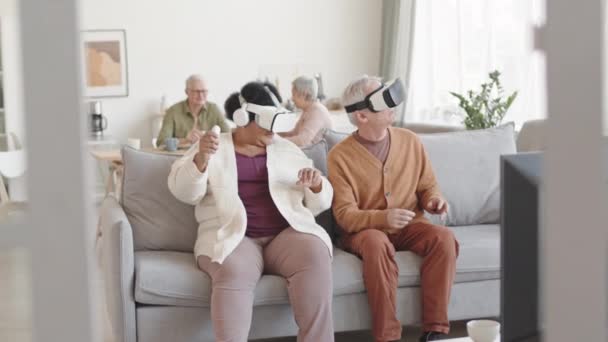 Medium Long Amused Man Woman Wearing Virtual Reality Headsets Sitting — Stock Video