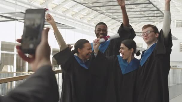 Visão Traseira Homem Irreconhecível Fazendo Foto Quatro Jovens Graduados Multiétnicos — Vídeo de Stock