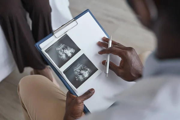 Close African Doctor Holding Clipboard Examining Ultrasound Image Patient Visiting — Stock Photo, Image