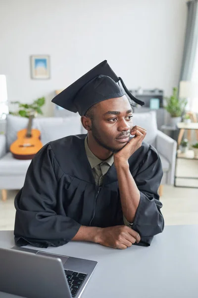 Vertical Portrait Pensicve African American Man Wearing Graduation Gown Home — Stock Photo, Image