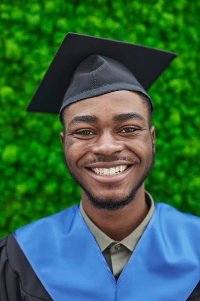Pionowy Portret Szczęśliwego Afroamerykanina Noszącego Czapkę Dyplomową Uśmiechającego Się Kamery — Zdjęcie stockowe
