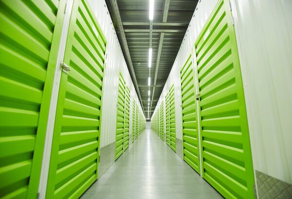 Image of empty warehouse with green storage boxes