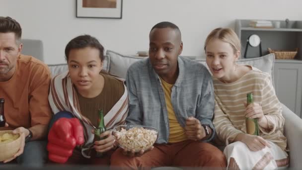 Tracking Left Diverse Friends Sitting Couch Living Room Drinking Beer — Stock Video