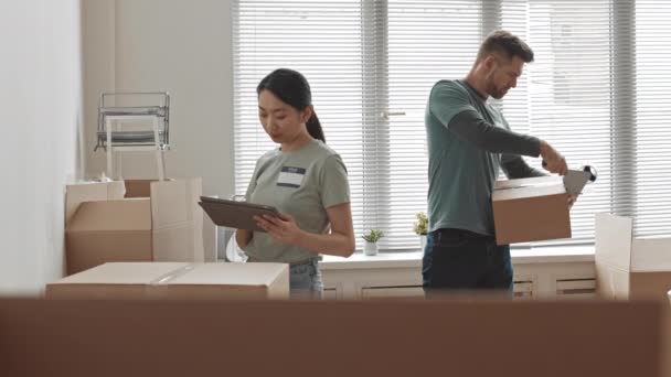 Medium Slowmo Young Asian Female Volunteer Looking Tablet Display Checking — Stock Video