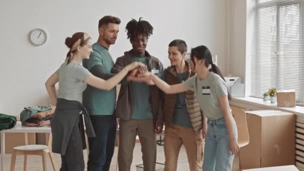 Medium Slowmo Cheerful Multi Ethnic Volunteer Team Putting Hands Together — Stock video