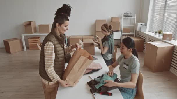 Mittlere Langsamkeit Multiethnischer Freiwilliger Die Kleidung Und Essen Bringen Die — Stockvideo