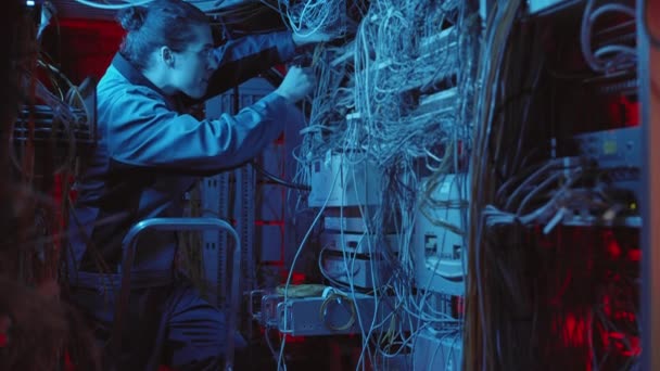 Tilting Young Caucasian Workman Wearing Glasses Standing Stepladder Repairing Hardware — Stock video