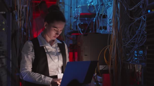 Medium Young Female Caucasian Programmer Wearing Formalwear Sitting Dark Switchboard — Stock video