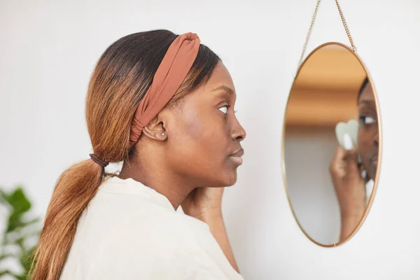 Νεαρή Αφρο-Αμερικανίδα κοιτάζει τον καθρέφτη — Φωτογραφία Αρχείου