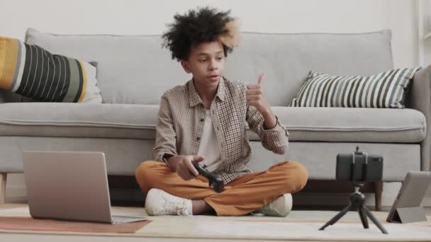 Full Shot Cheerful African Boy Sitting Floor Playing Computer Game — Stock Video