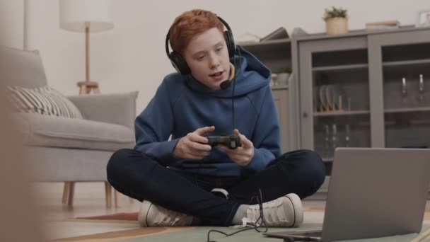 Full Shot Ginger Haired Caucasian Boy Sitting Legs Crossed Room — Stock Video