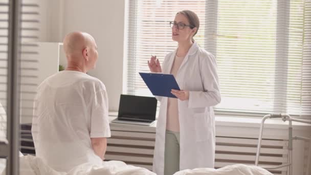 Panning Medium Slow Shot Cheerful Female Doctor Telling Cancer Patient — Vídeo de stock