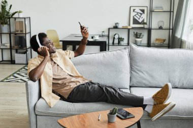 Evdeki kanepede dinlenen adam.