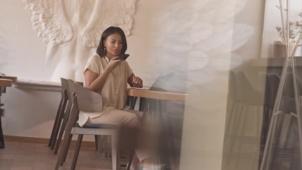 Tilting Left Full Shot Modern Mixed Race Woman Sitting Table — Stock Video