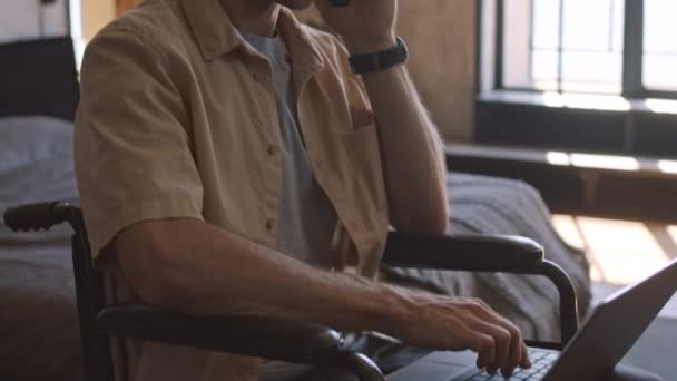 Tilting Handicapped Caucasian Businessman Using Portable Computer Talking Mobile Phone — Stock Video