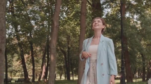 Tracking Medium Long Young Caucasian Woman Smiling Walking Park Summertime — Stok video