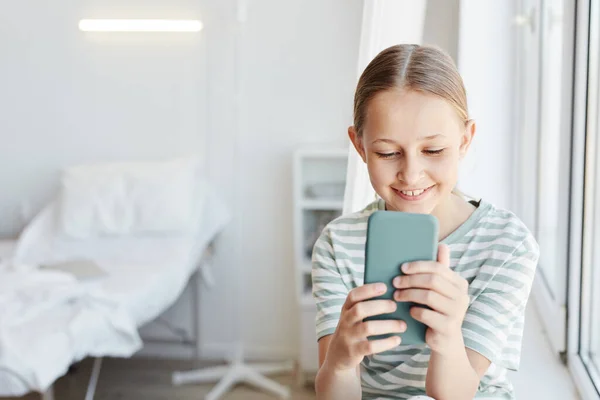 Girl using Smartphone in Hospital — стокове фото