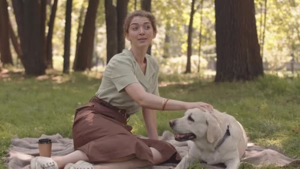 Full Shot Young Caucasian Woman Dog Sitting Blanket Top Lawn — Αρχείο Βίντεο