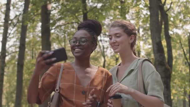 Waist Two African Caucasian Female Friends Smiling Taking Selfies Using — Stock Video