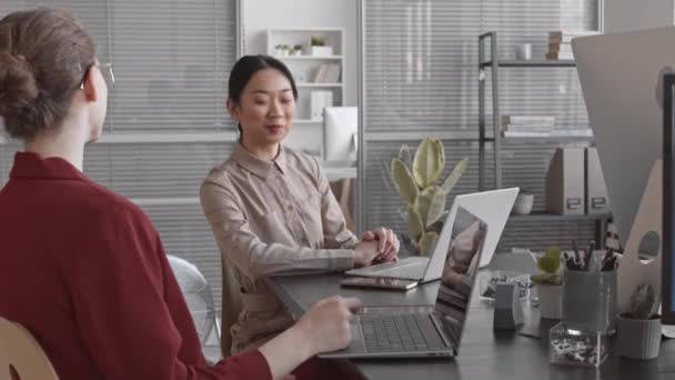 Moyenne Longue Jeune Femme Asiatique Assise Bureau Parlant Une Collègue — Video