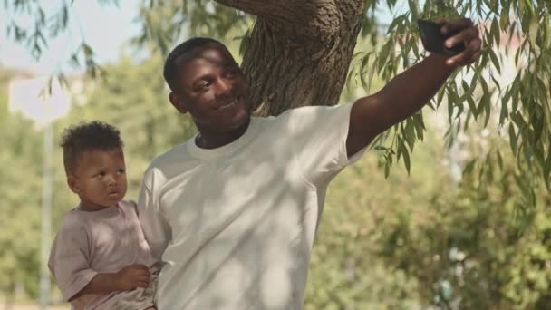 Slowmo Medium Shot African American Man Holding Toddler Son Taking — Stock Video