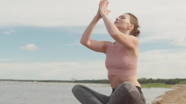 Powolne Ujęcie Młodej Zrelaksowanej Kobiety Lotosu Medytującej Samotnie Piaszczystej Plaży — Wideo stockowe