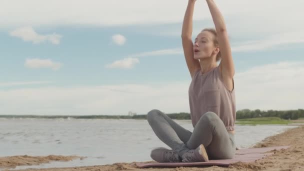 Jonge Ontspannen Vrouw Sportkleding Zittend Lotus Poseren Met Ogen Dicht — Stockvideo