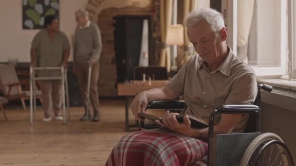 Slowmo Shot Grey Haired Senior Man Sitting Wheelchair Reading Book — Stock Video