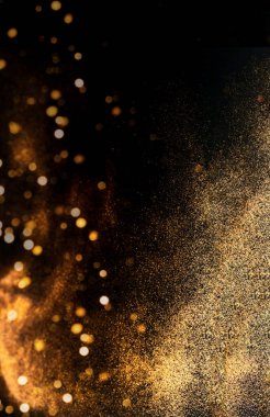 Abstract dark background with golden sparkles. Blurred effect. Concept for festive background or for project.Copy space clipart