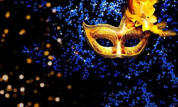 Masquerade mask on dark background with blue sparkles. The concept of traditional holidays. Creative copy space. — Stock Photo, Image