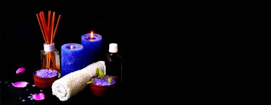 Spa composition with light candleson dark background. Wellness at home. 