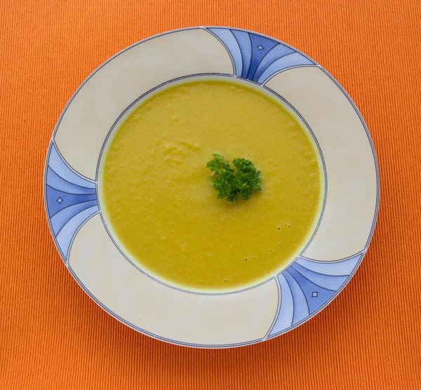 Plate of pumpkin soup on  orange background — Stock Photo, Image