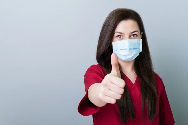 Dentist woman showing like gesture on gray copy space — Stock Photo, Image