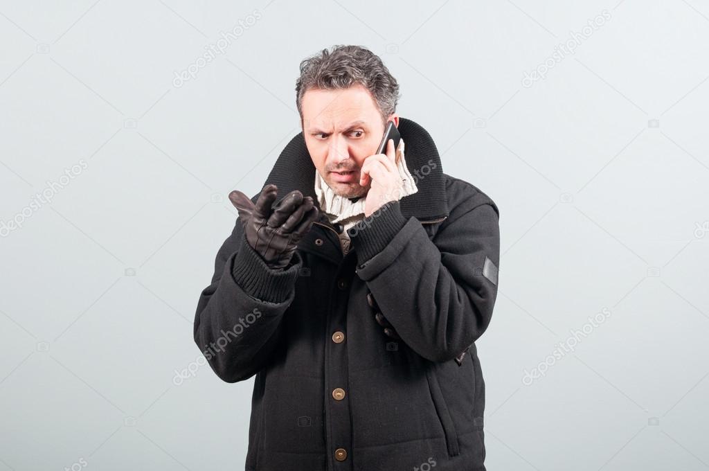 Nervous male having a conversation on cellphone 