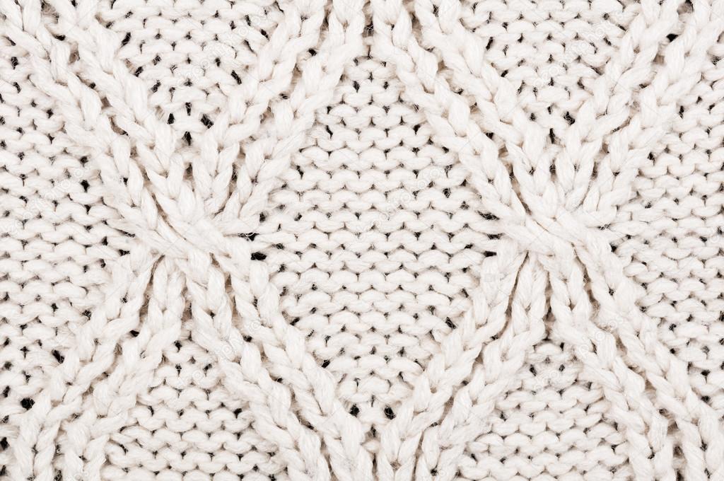 Close-up of beige knitted winter sweater with pattern