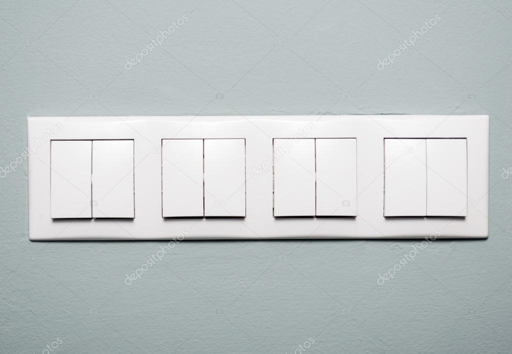 Close-up of multiple light switches on blue background