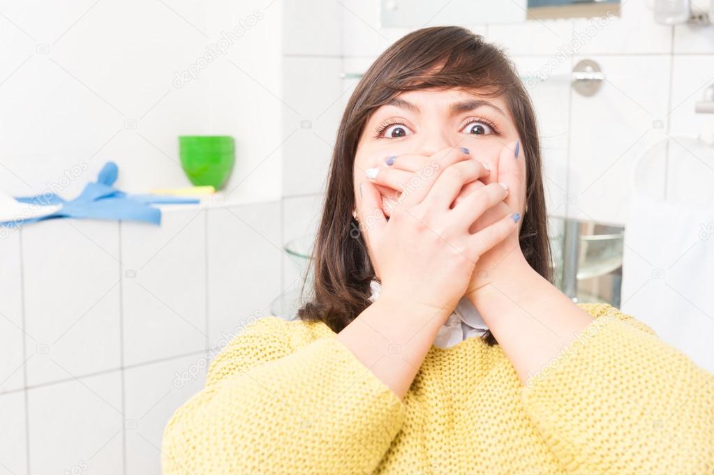 Close-up portrait of terrified woman scared at dentist visit