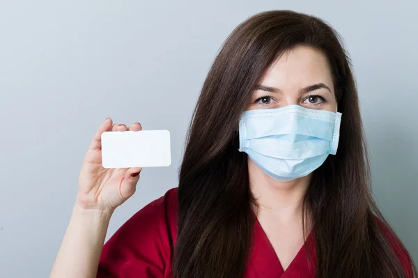 Woman doctor holding a blank white card — Stock Photo, Image