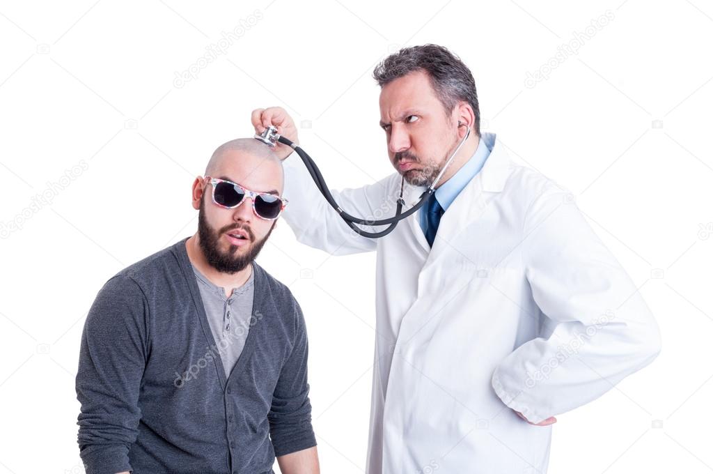 Male doctor consulting a crazy patient with stethoscope 
