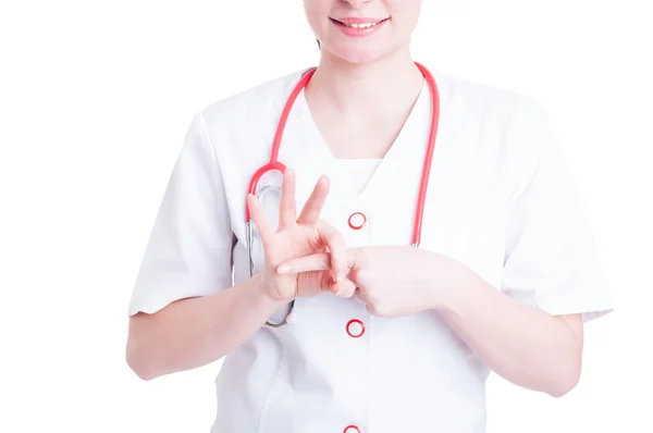 Female doctor smiling and making a naughty gesture — Stock Photo, Image