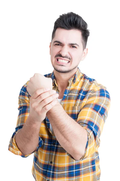 Portrait of angry young man with pain in his wrist — Stock Photo, Image