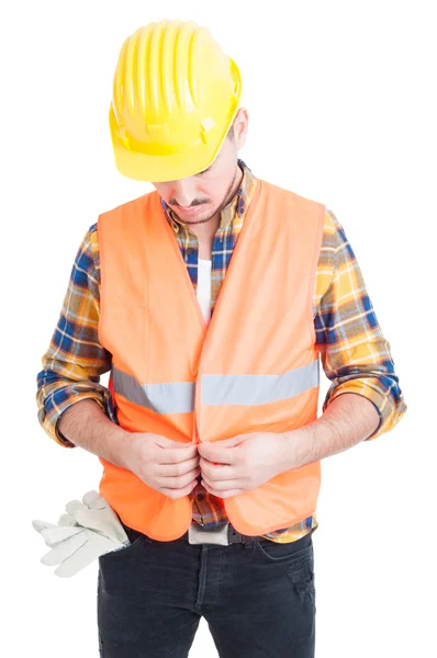 Attractive engineer with gloves in his poket getting dressed — Stock Photo, Image